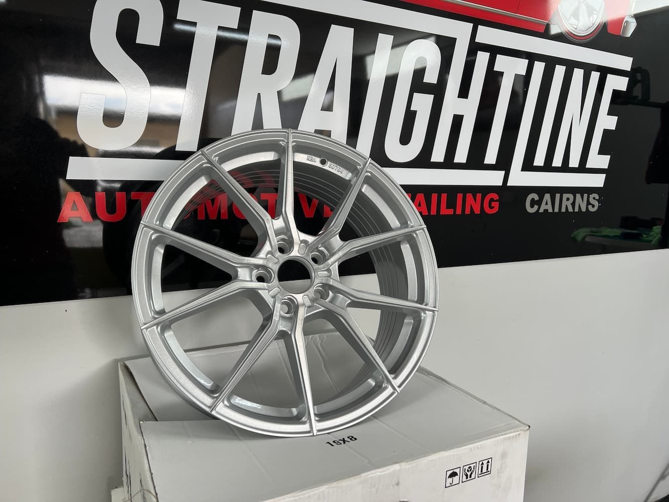 A Silver Wheel is Sitting on Top of a White Box — Straightline Detailing Cairns in Bungalow, QLD