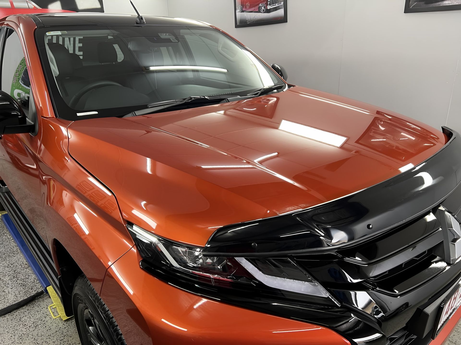 Orange SUV With Black Grille Inside an Auto Shop — Straightline Detailing Cairns in Bungalow, QLD