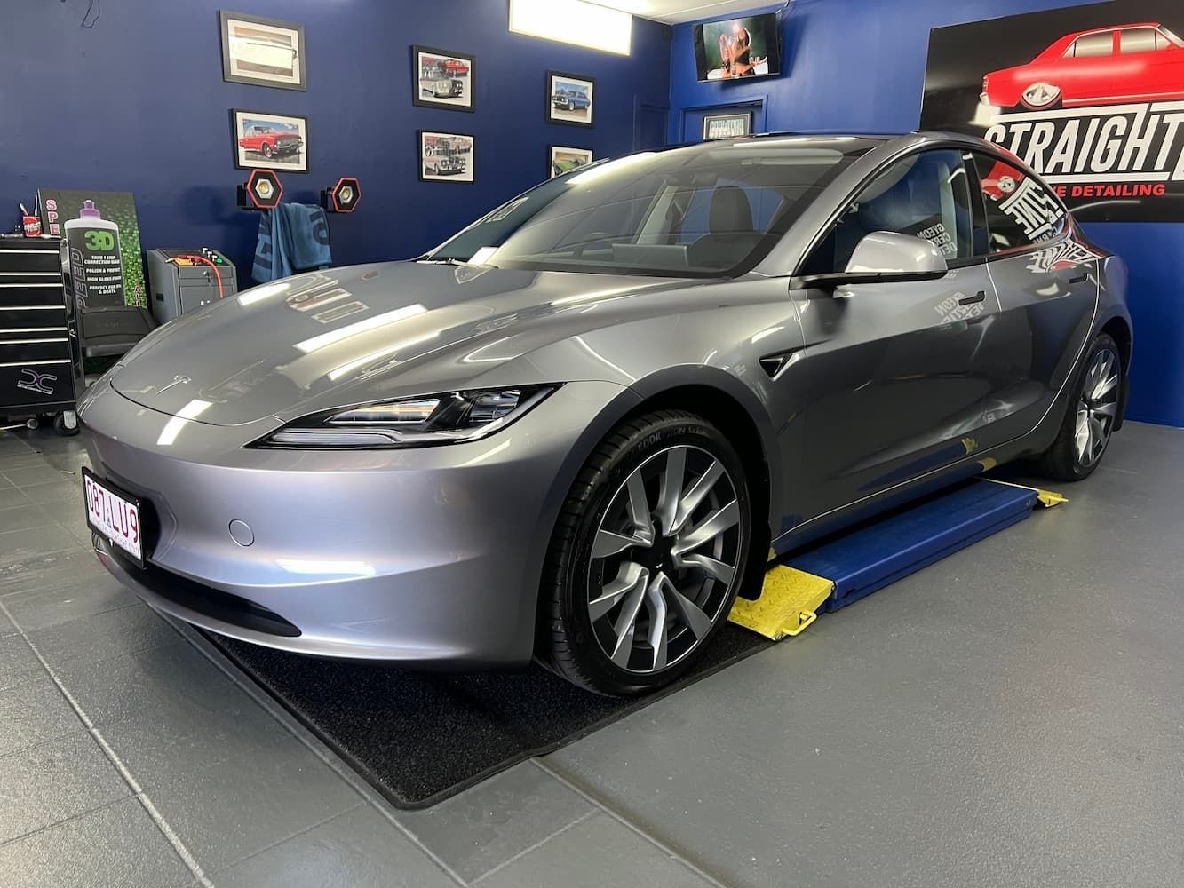 Silver Tesla on A Dynamometer in A Car Shop Garage — Straightline Detailing Cairns in Bungalow, QLD