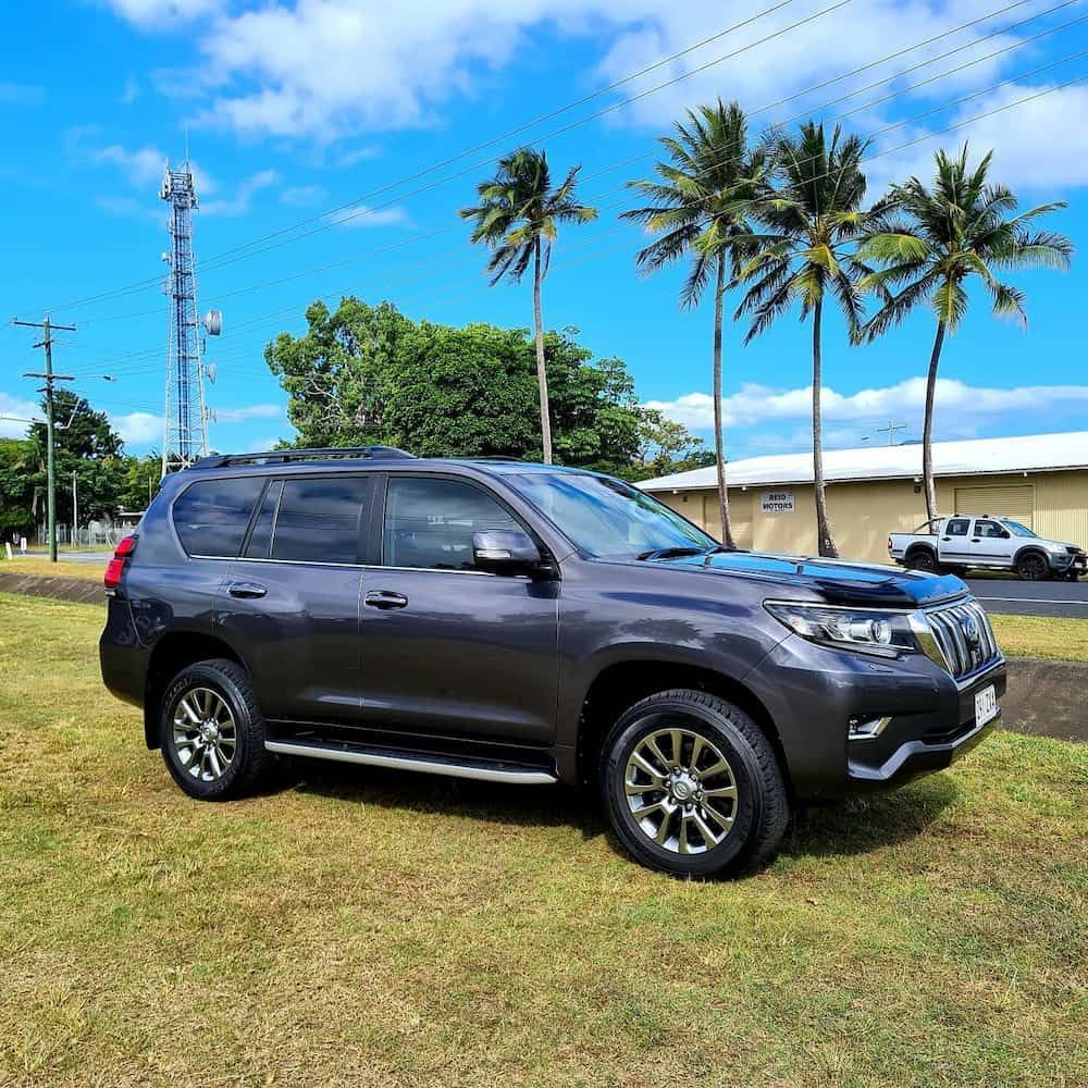 Dark Gray SUV Parked on Grass — Straightline Detailing Cairns in Bungalow, QLD