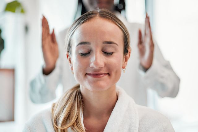 a woman is getting a massage at a spa with her eyes closed .
