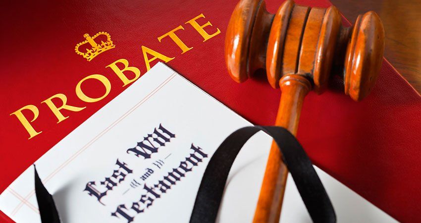 Gavel resting on a last will and testament as well something that says probate