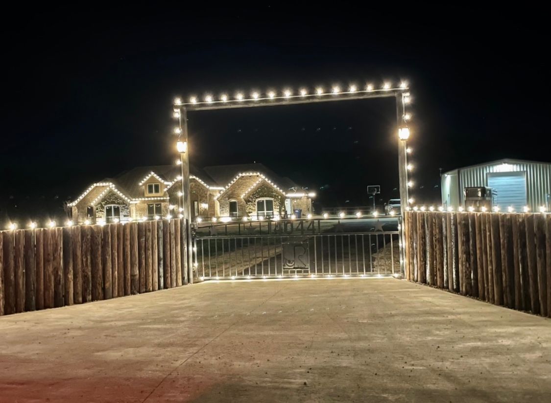 white christmas lights fence and gate