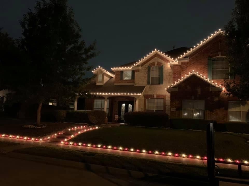 red and white walkway and white christmas lights on house