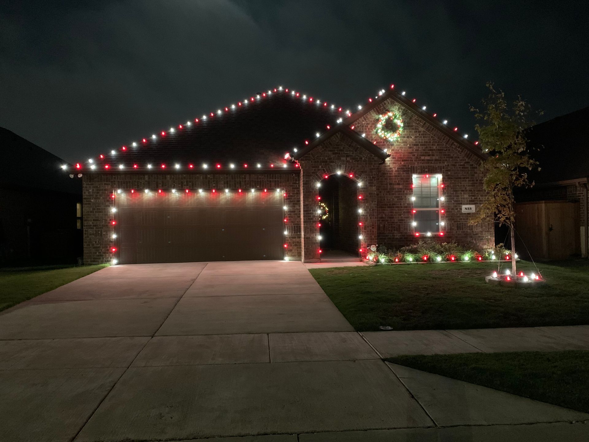 brick home with red and white christmas lights