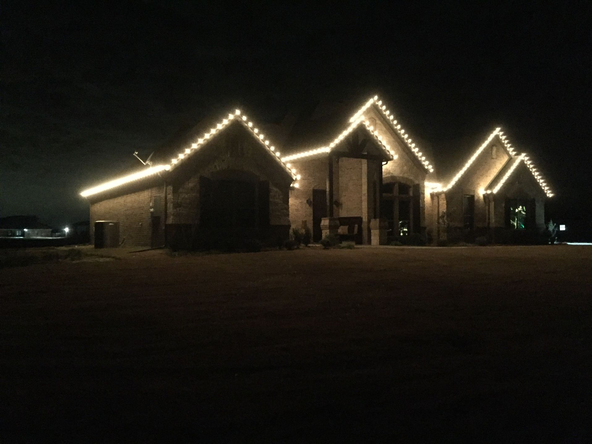 white christmas lights on ranch style home