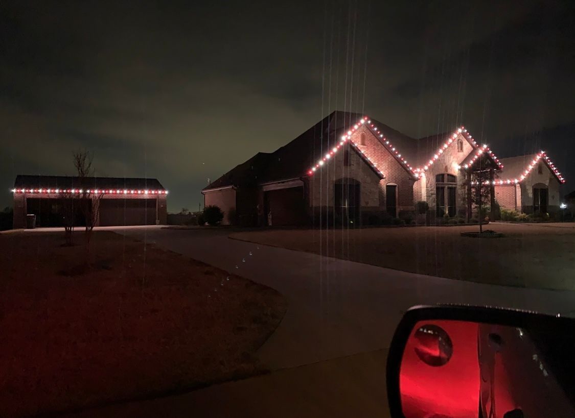 red and white christmas lights on barn