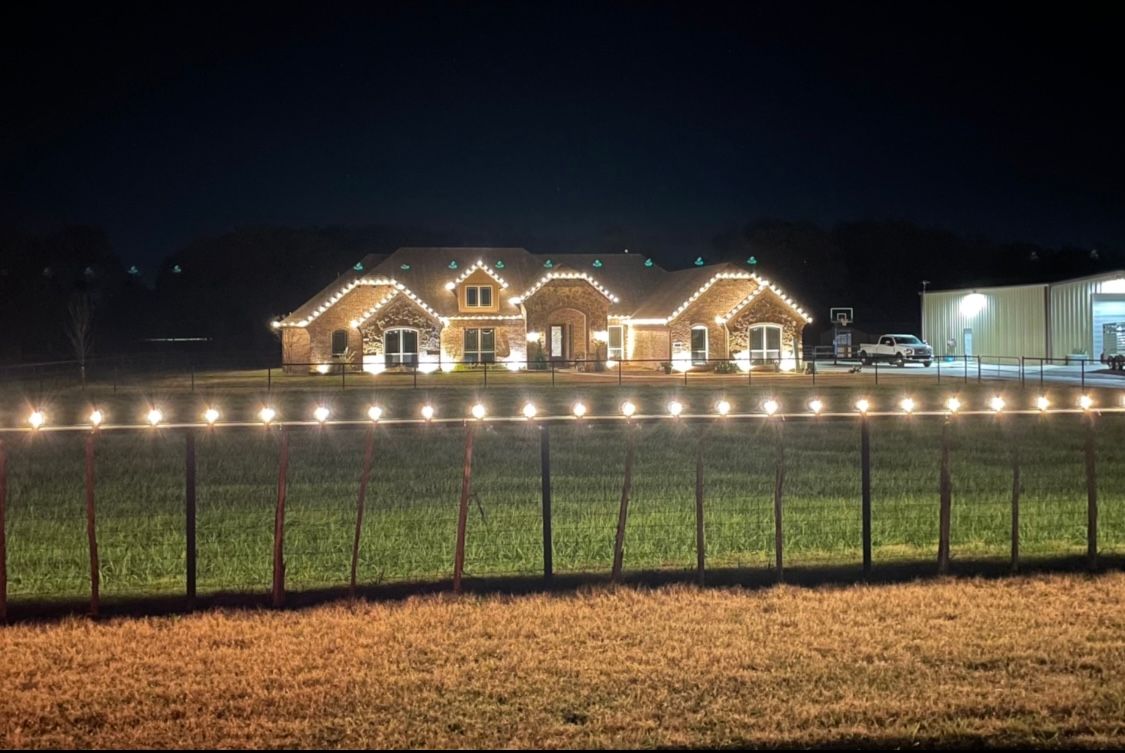 white christmas lights along fence line