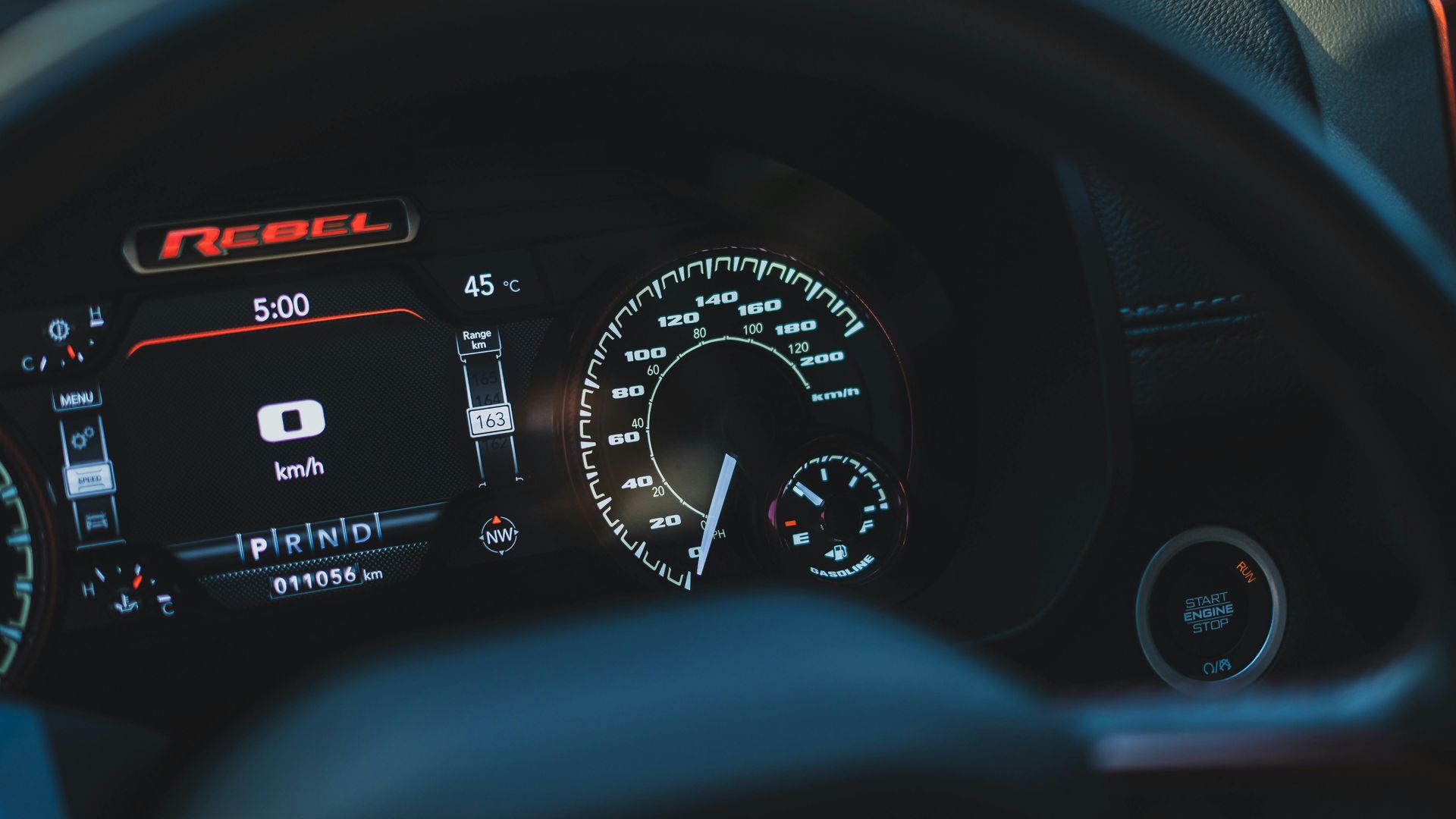 A close up of a car dashboard with a steering wheel.