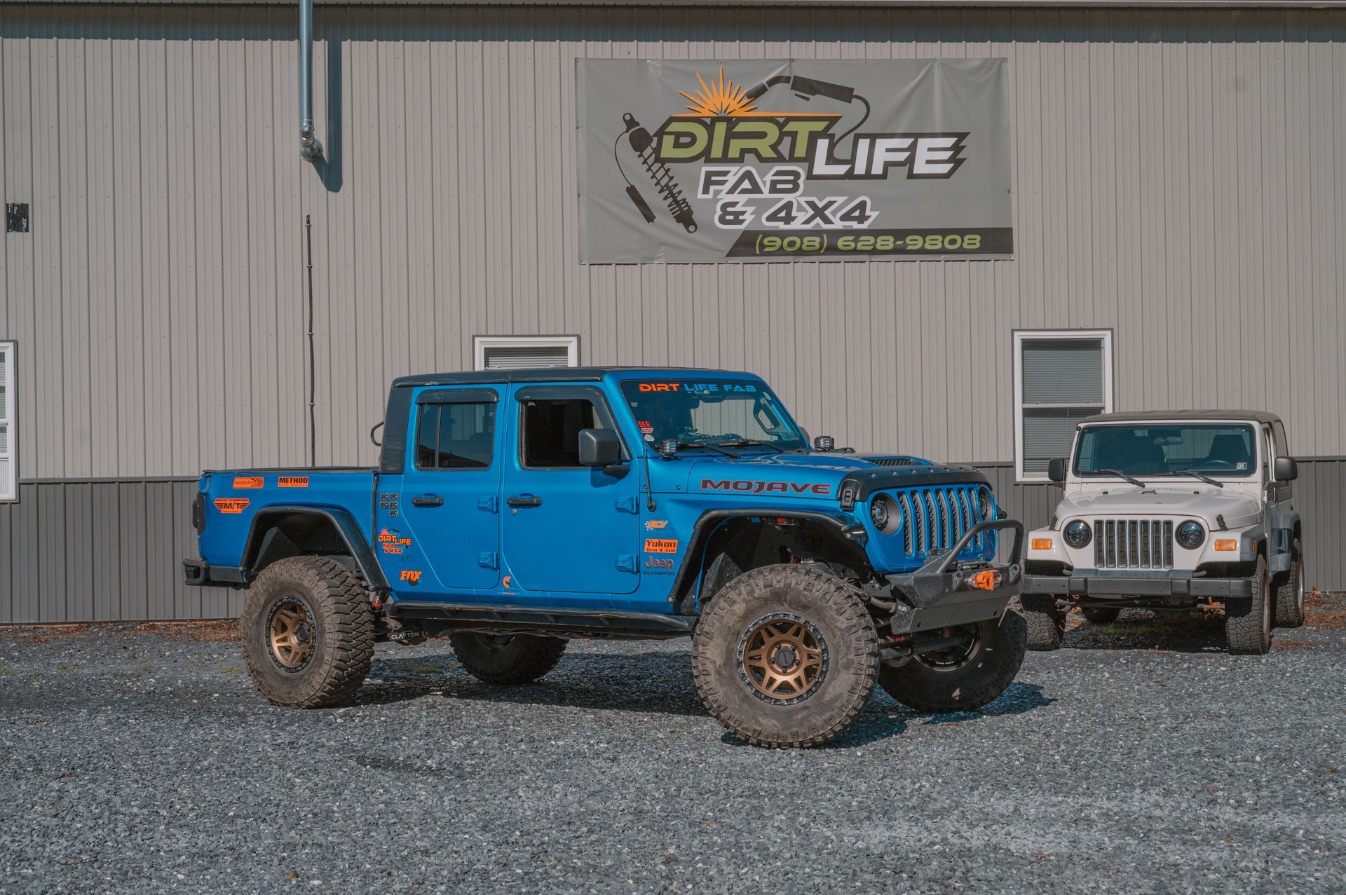 A bunch of tires are stacked on top of each other in a garage.  | DirtLife Fab & 4x4