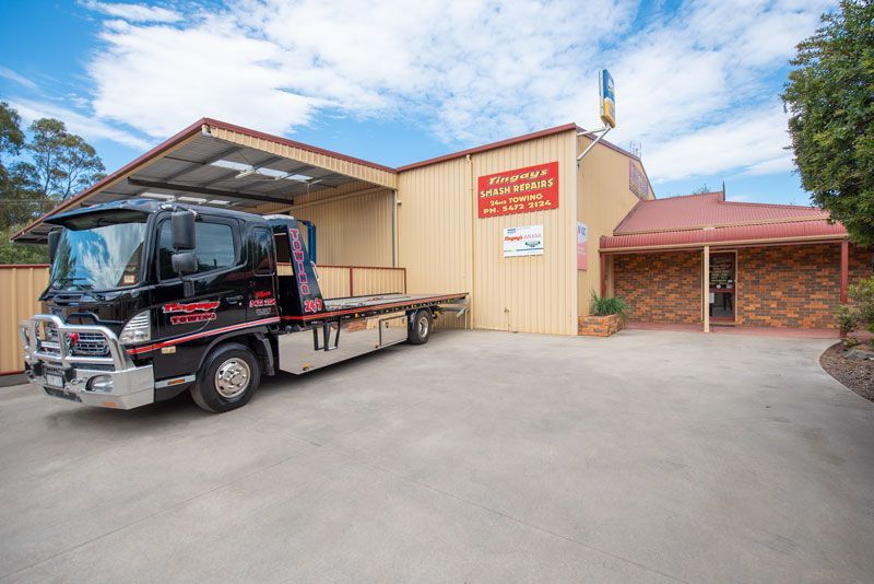 A tow truck is parked in front of a building.