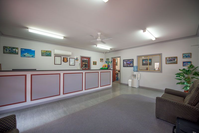 A lobby with a couch and a counter in a hotel.
