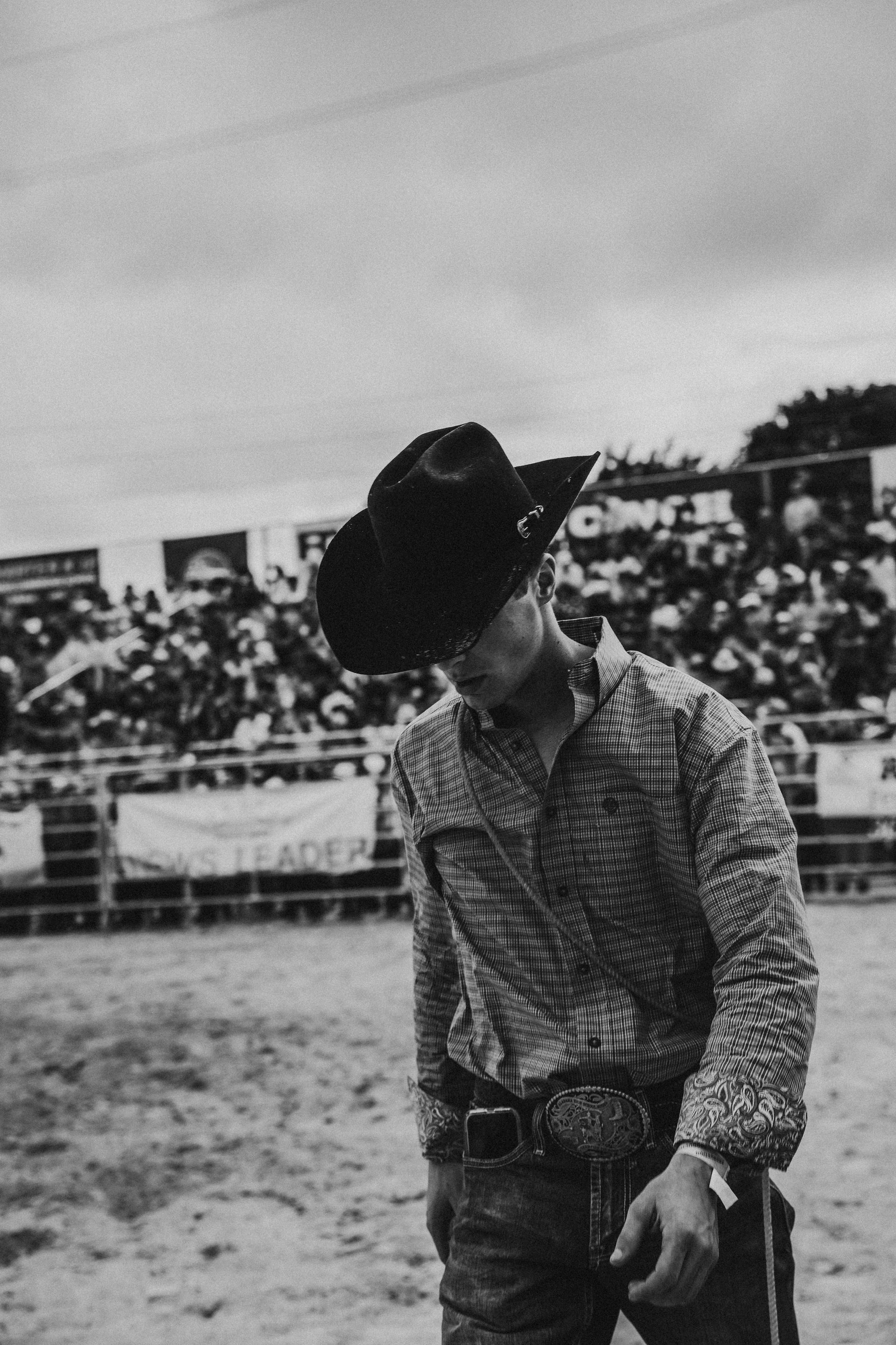 A black and white photo of a man wearing a cowboy hat
