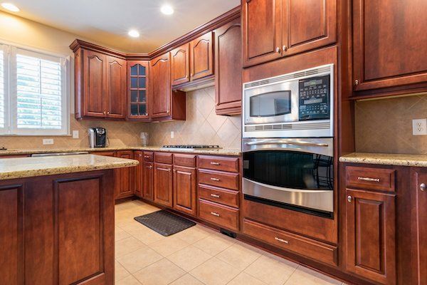 Professional wood floor refinisher final mopping a newly refinished hardwood floor