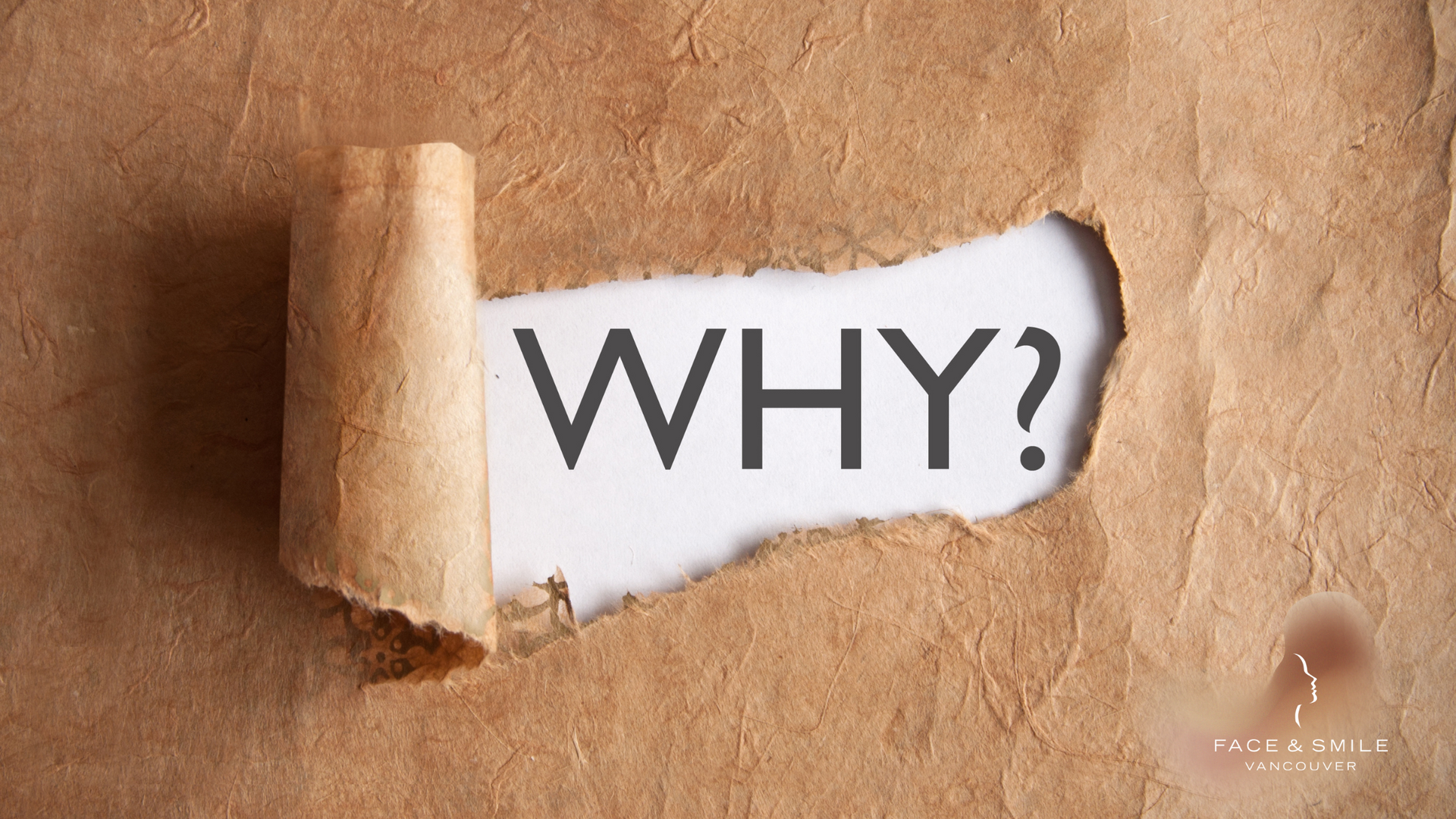 A piece of torn paper with the word why written on it