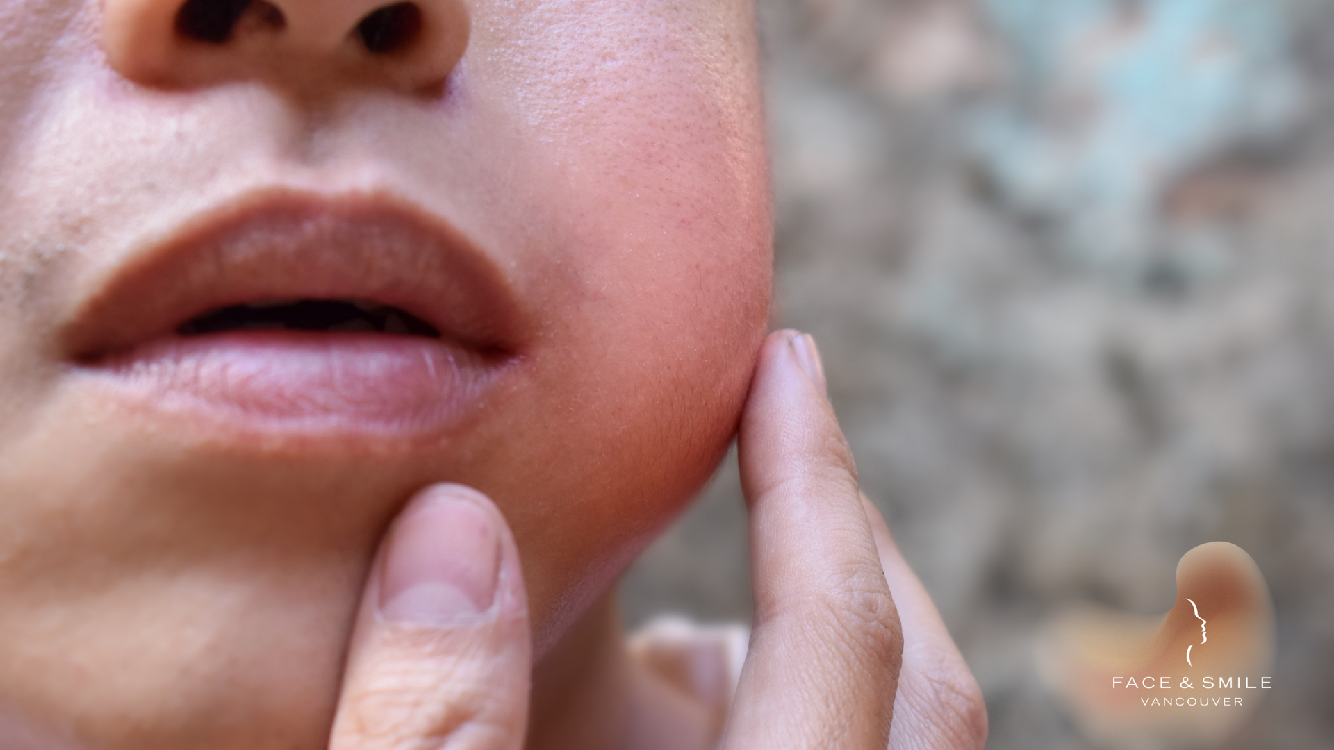 A close up of a person 's face with their hand on it.