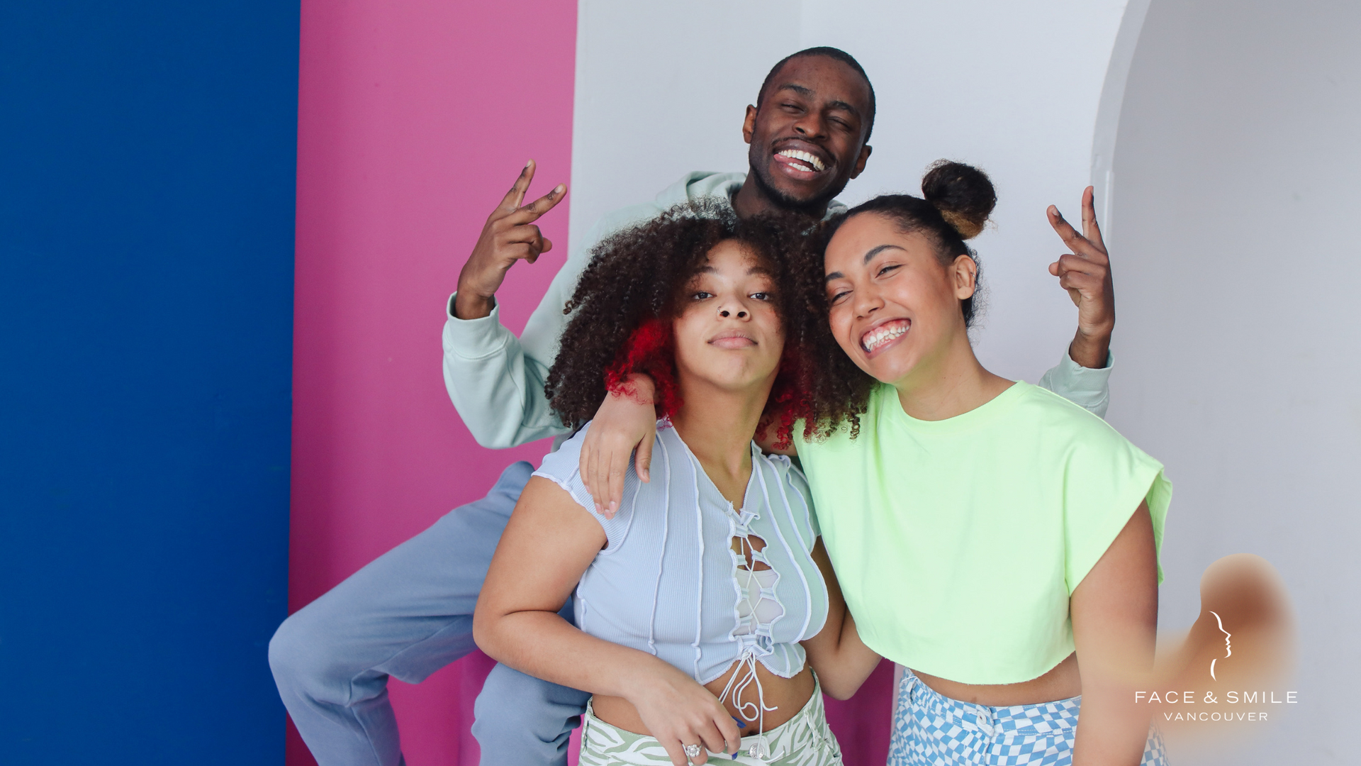 A man and two women are posing for a picture together.