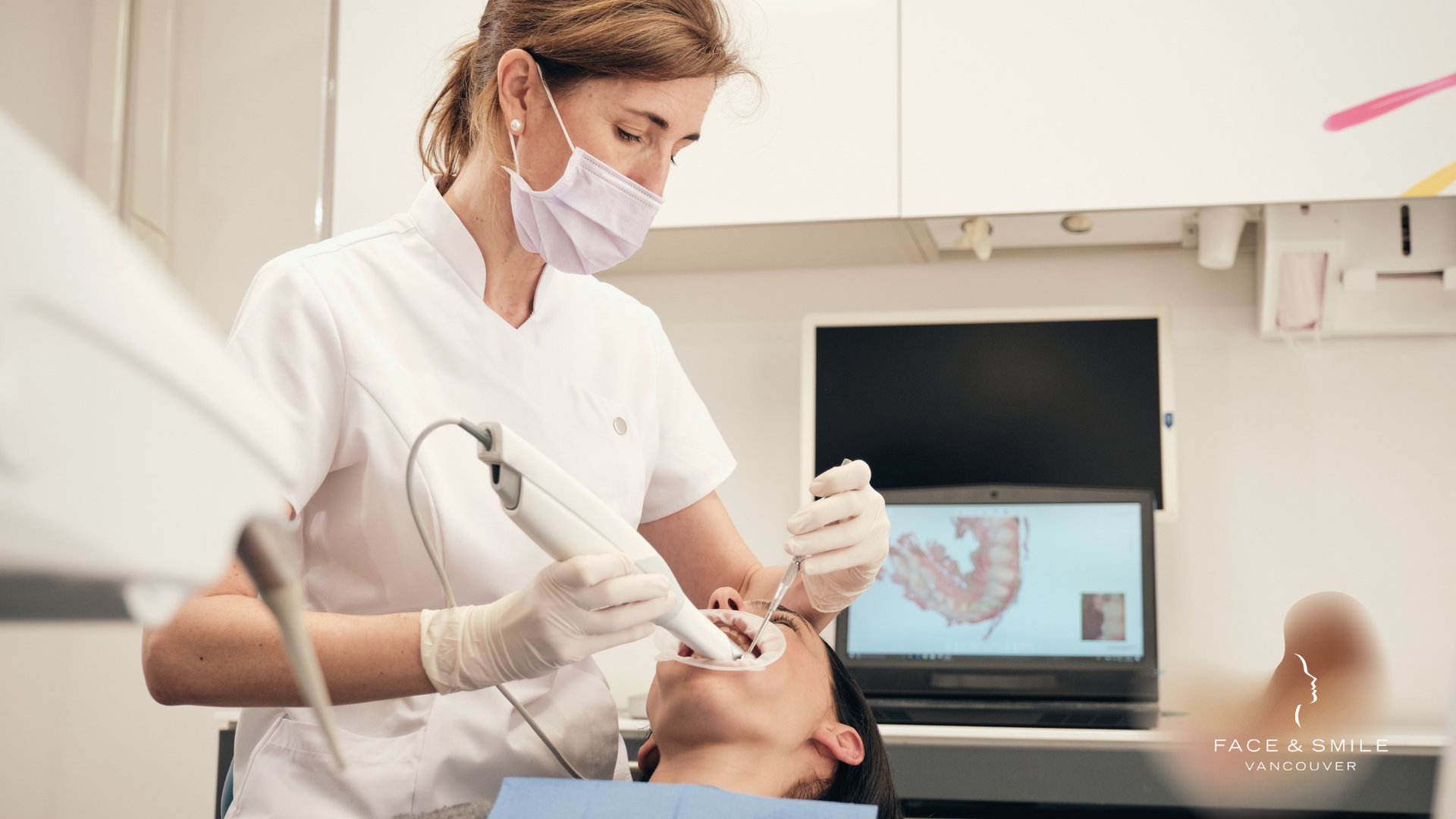 A female dentist is examining a patient 's teeth in a dental office.