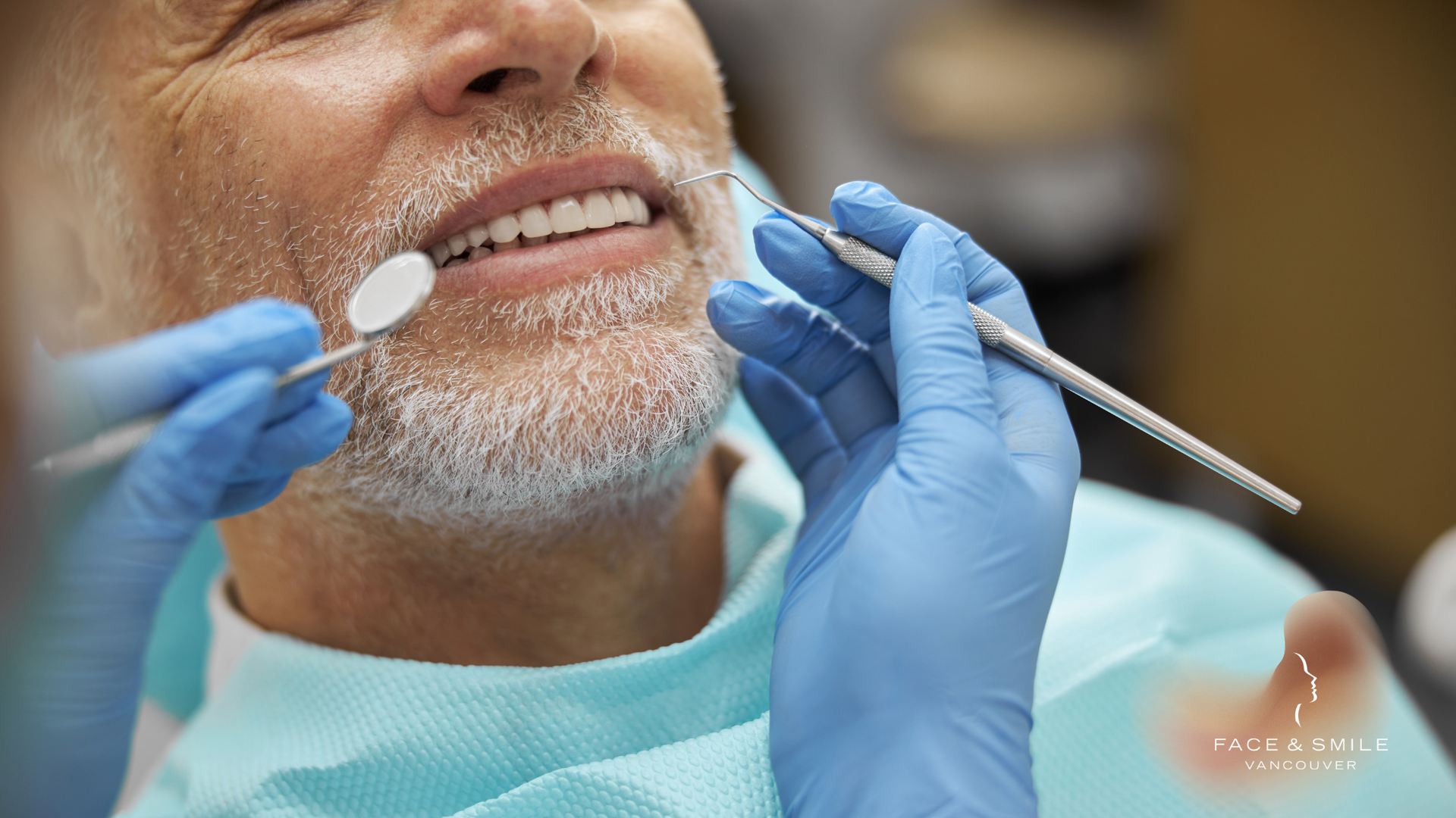 An older man is getting his teeth examined by a dentist.