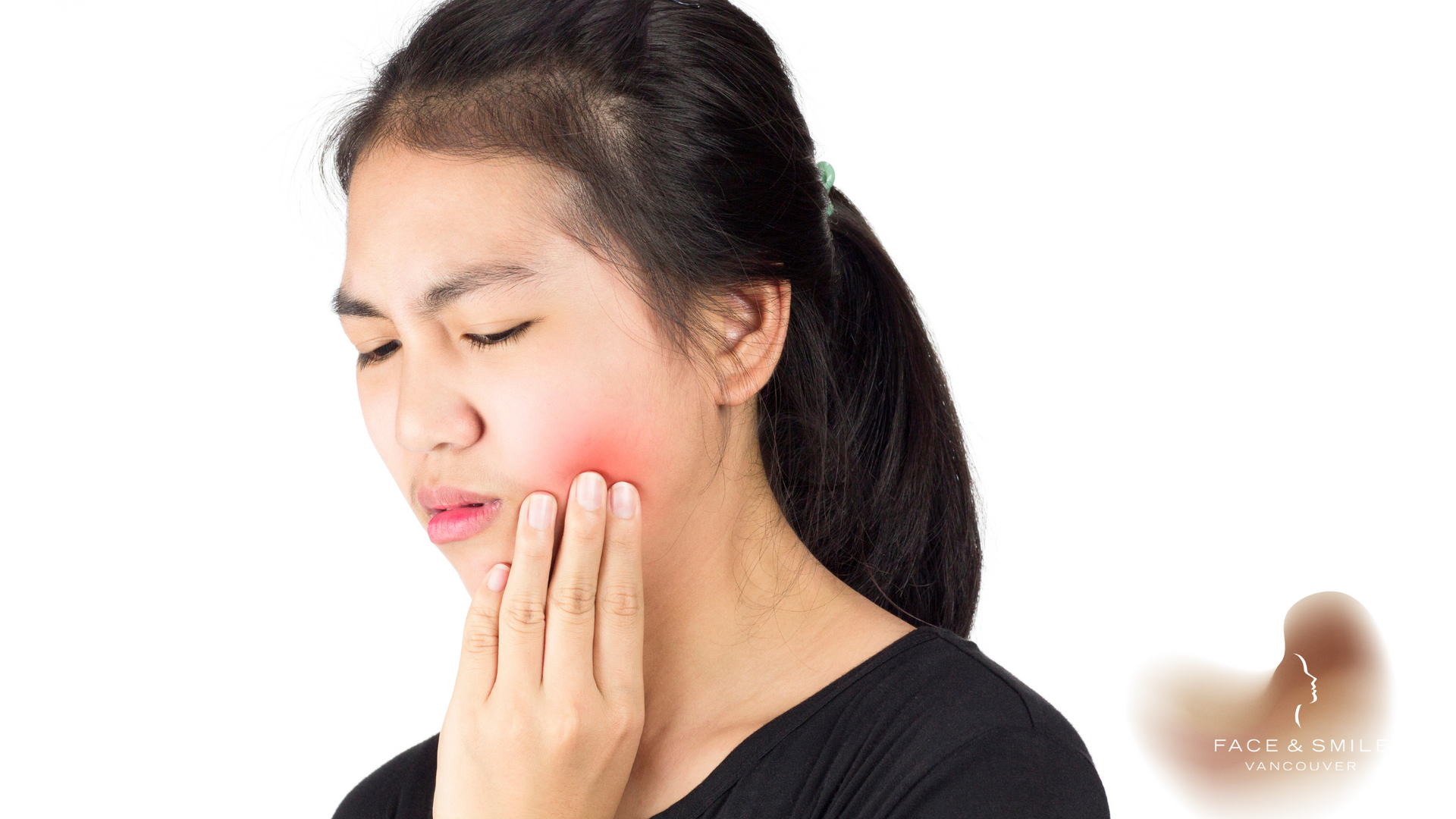 Woman with a hand on her cheek, showing a red, swollen area, indicating possible toothache.