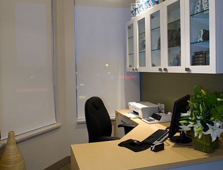 A desk with a computer and a printer on it