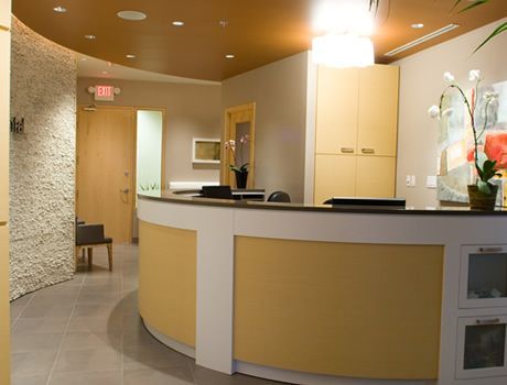 A dental office with a curved reception desk