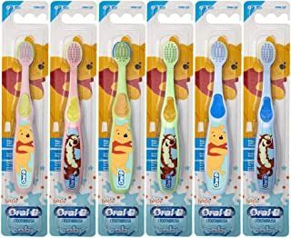 A row of oral b baby toothbrushes with winnie the pooh on them.
