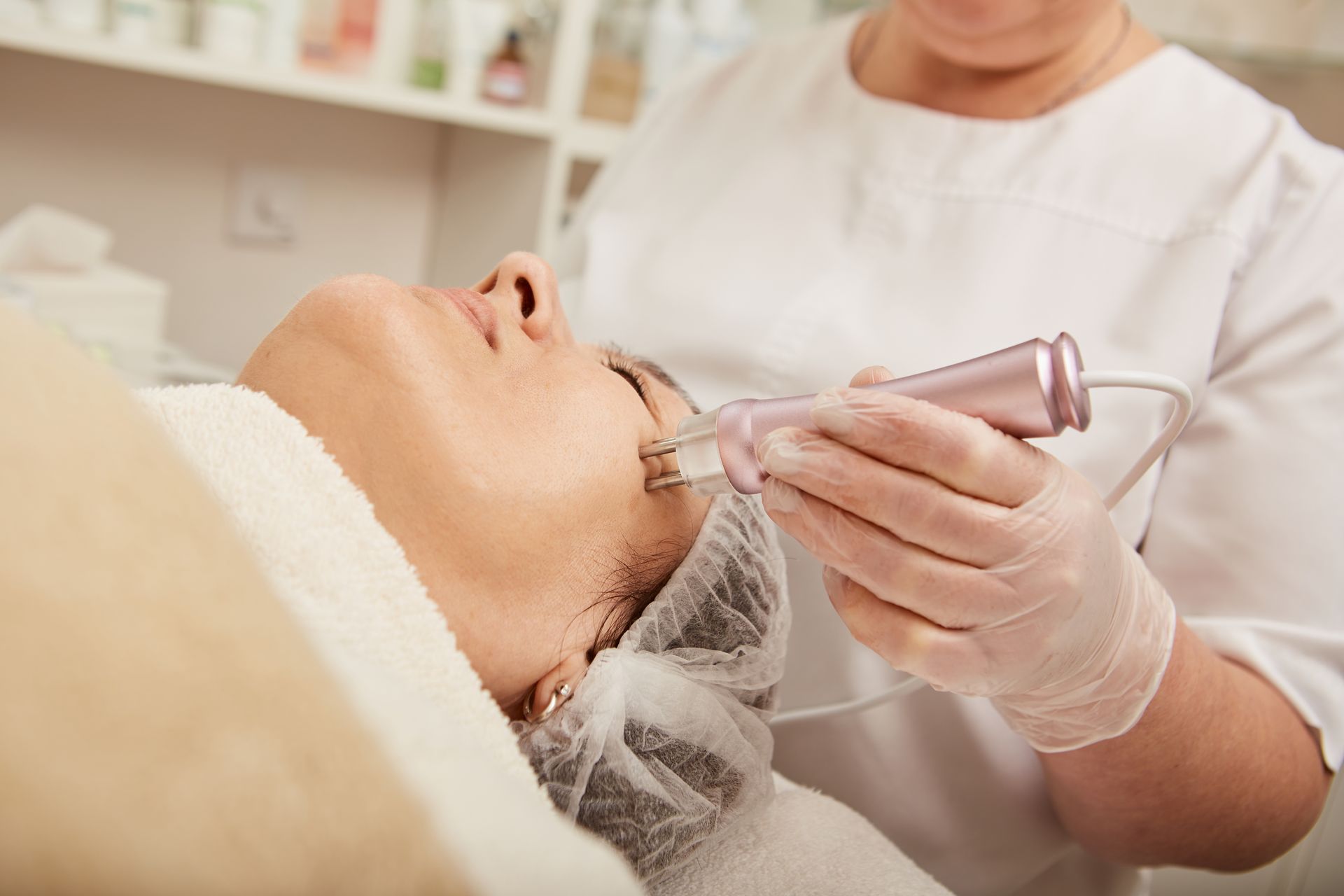 A woman is getting a facial treatment at a beauty salon.