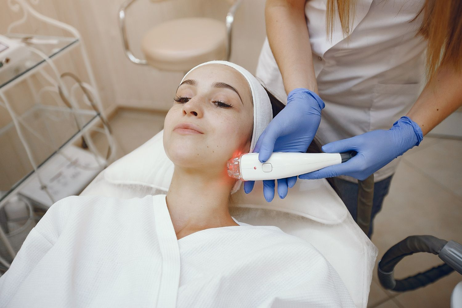 A woman is getting a facial treatment in a beauty salon.