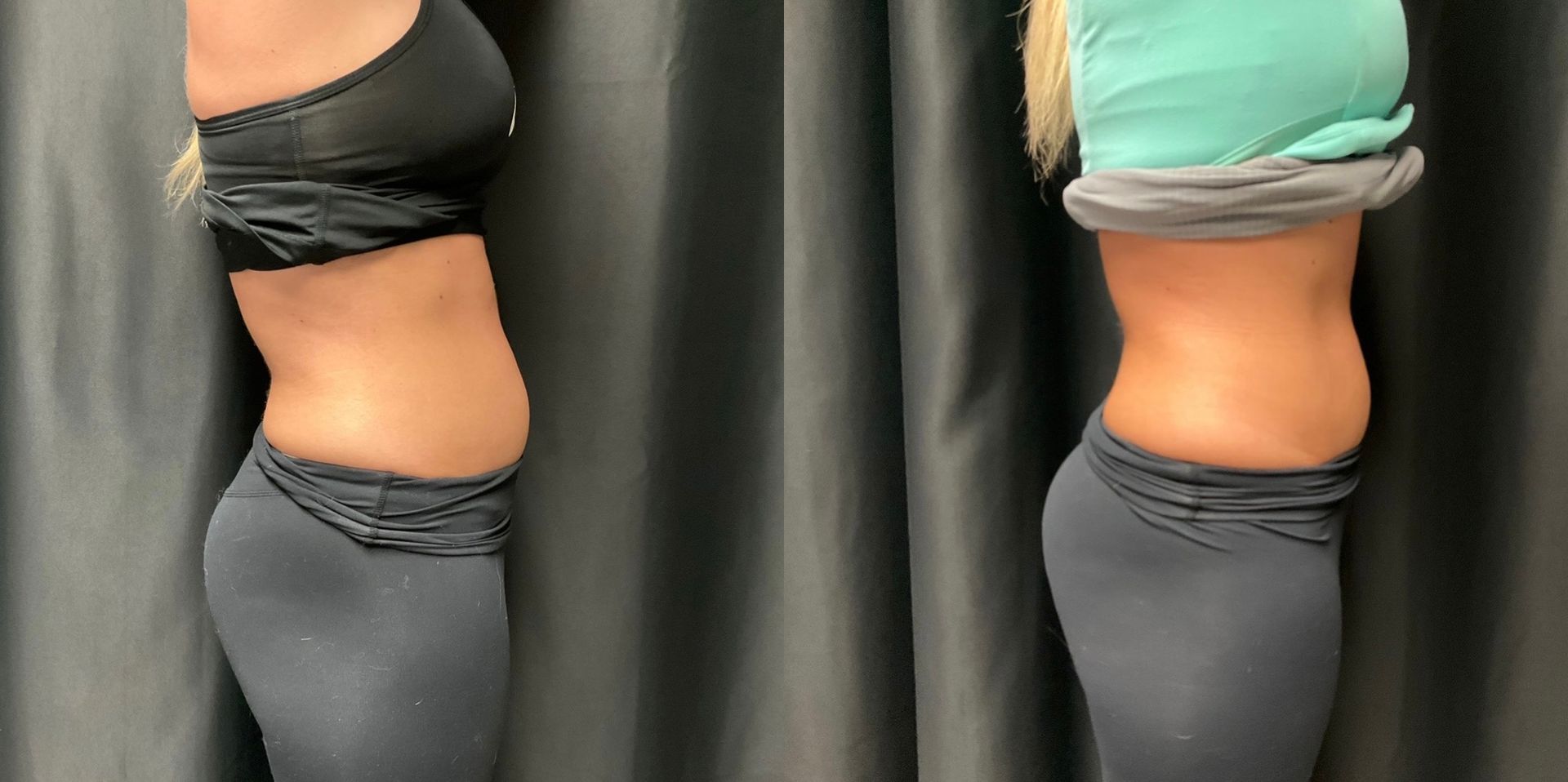 Two women are standing next to each other in front of a black curtain.