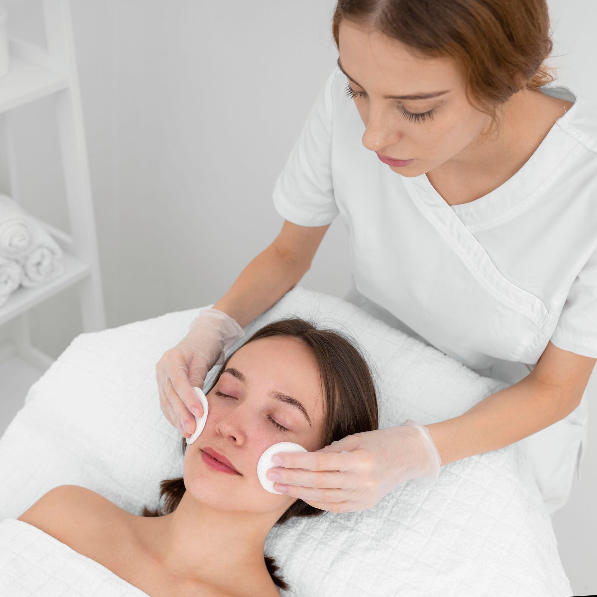 A woman is getting a facial treatment at a spa.