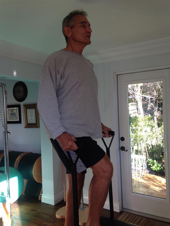 A man is standing on a machine in a room