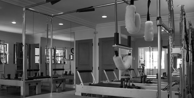A black and white photo of a pilates studio.