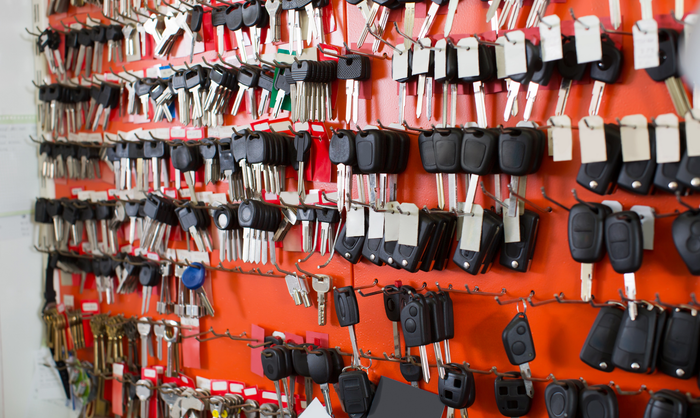 Wall of keys and key fobs for sale, orange background. Wall of keys and key fobs for sale, orange background.
