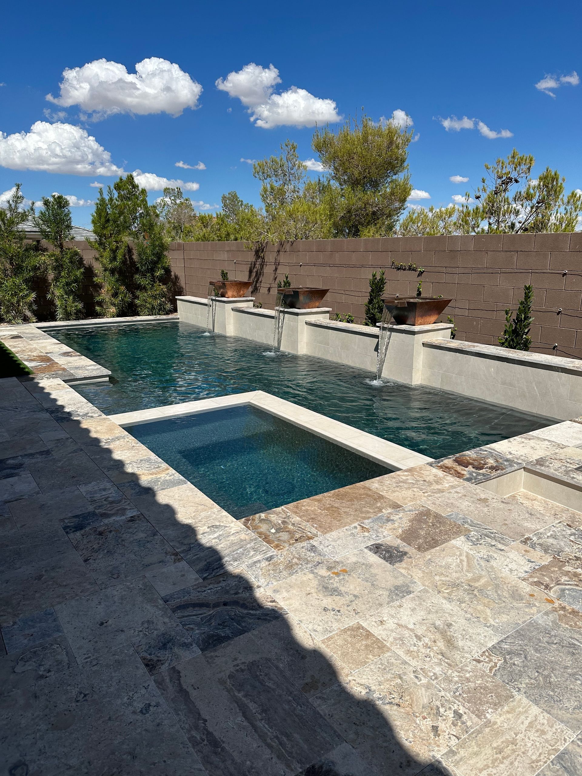 A large swimming pool with a fountain in the middle