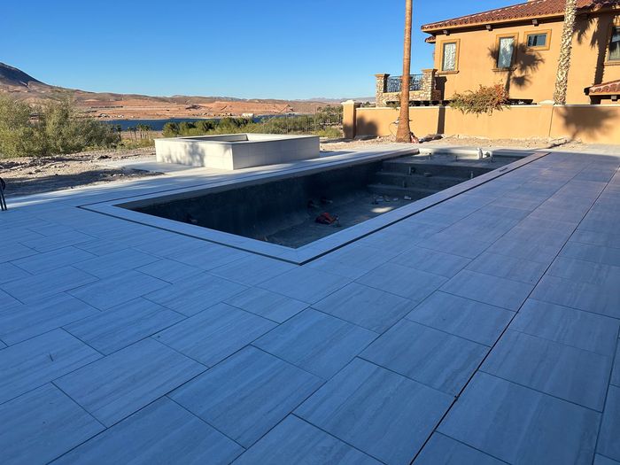 A large swimming pool is being built in front of a house