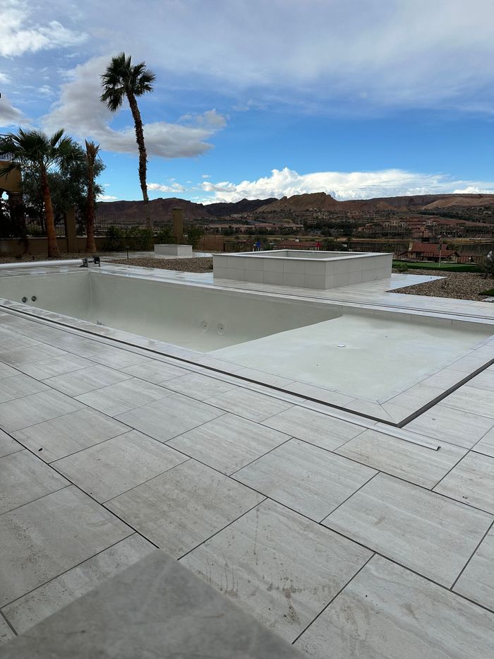 A swimming pool with a palm tree in the background