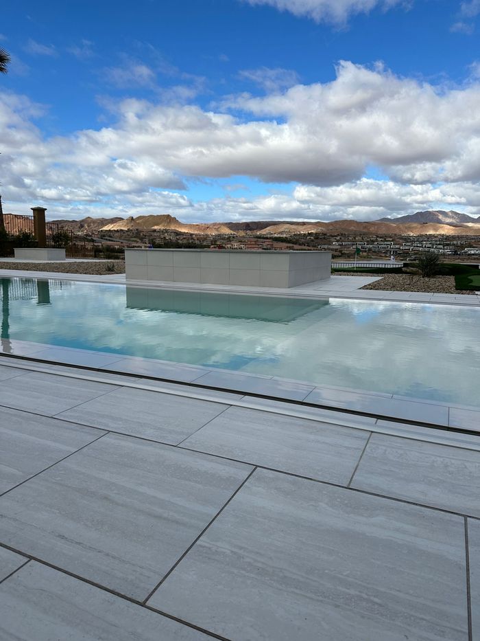 A large swimming pool with a city in the background