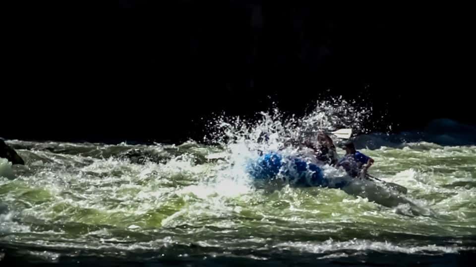 Person Riding a Raft Down a River