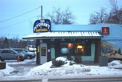 A restaurant called the hydrant is covered in snow