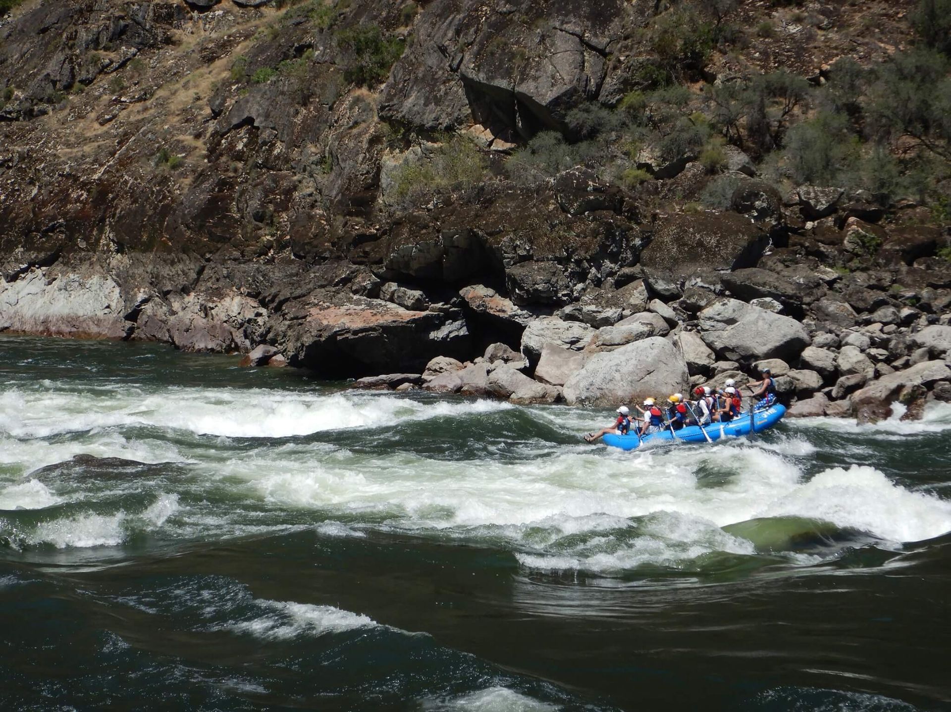 A Group of People Are Rafting Down a River