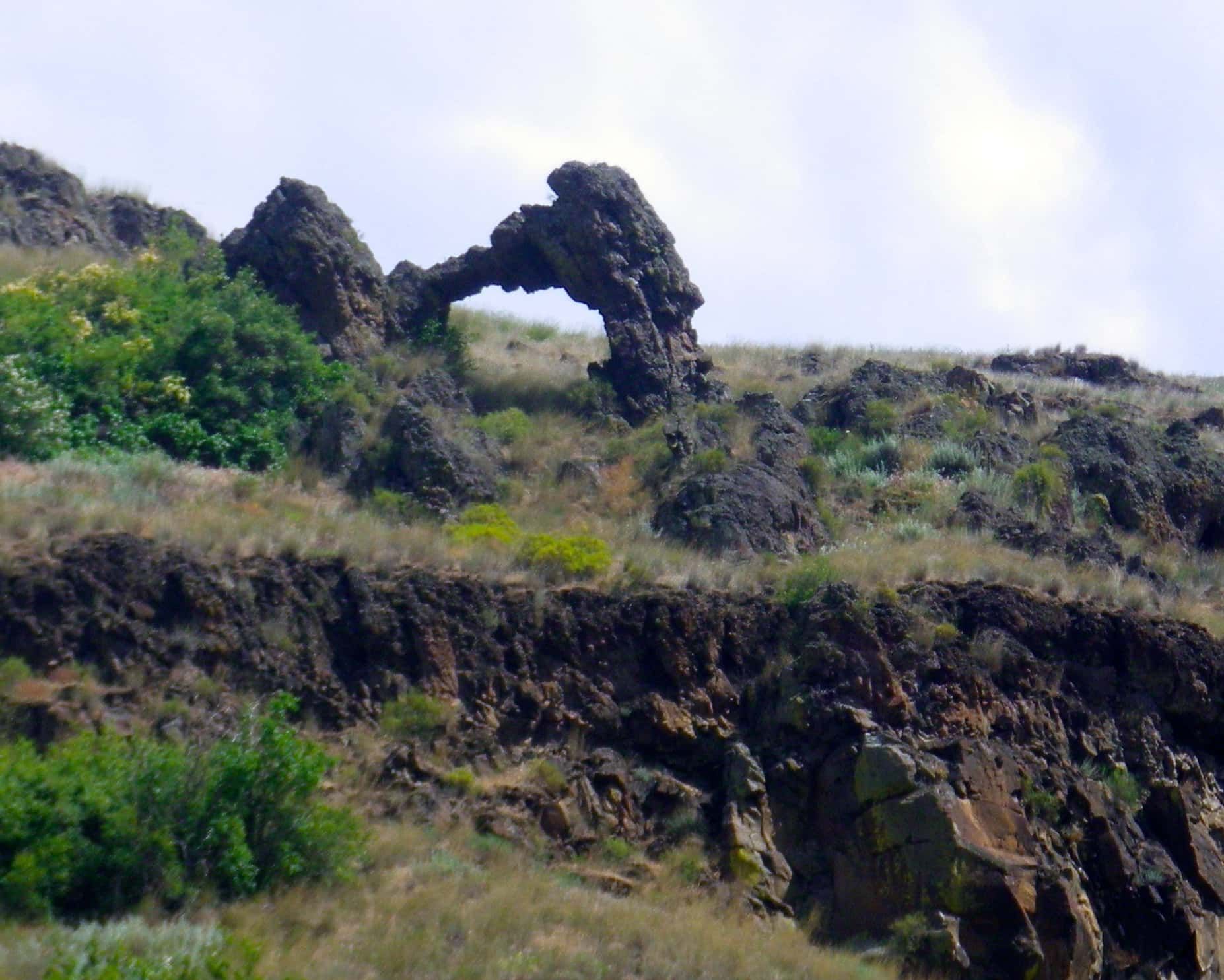 Rock Formation in The Middle of A Grassy Hillside