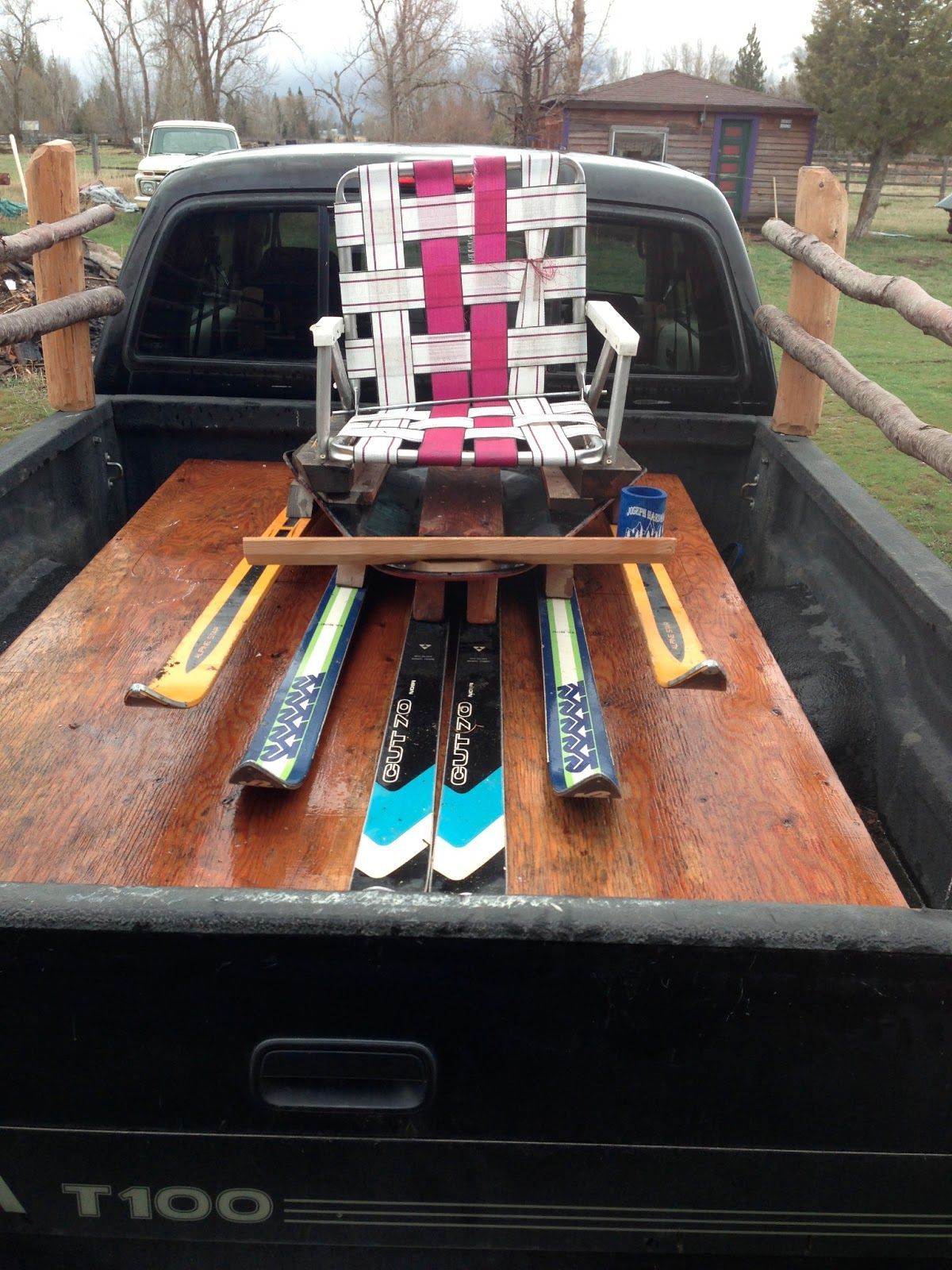 A t100 truck with skis and a chair in the back