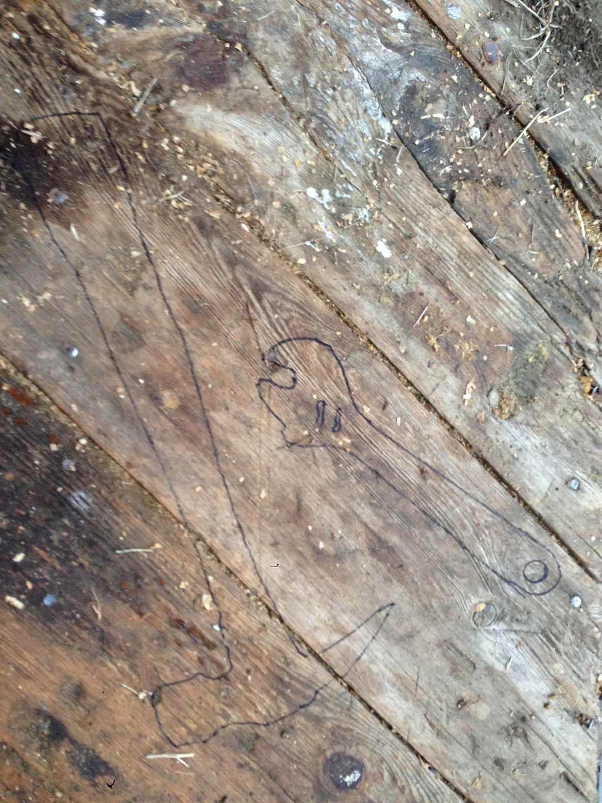 A close up of a wooden floor with a heart drawn on it.