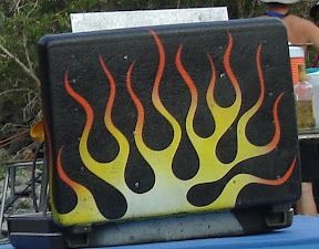 A black cooler with flames painted on it