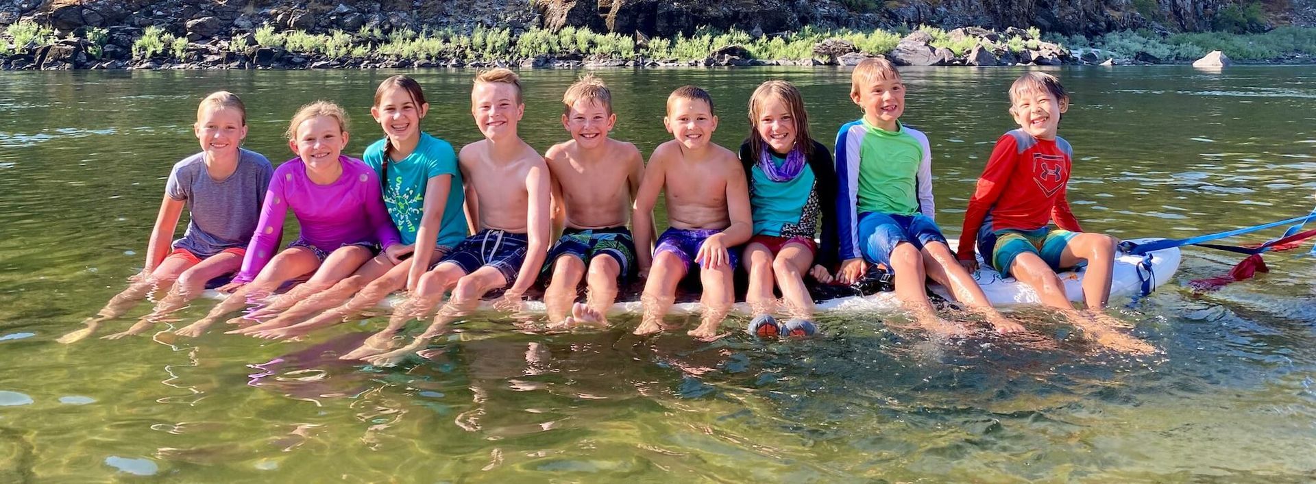 A Group of Children Are Posing for A Picture in the Water