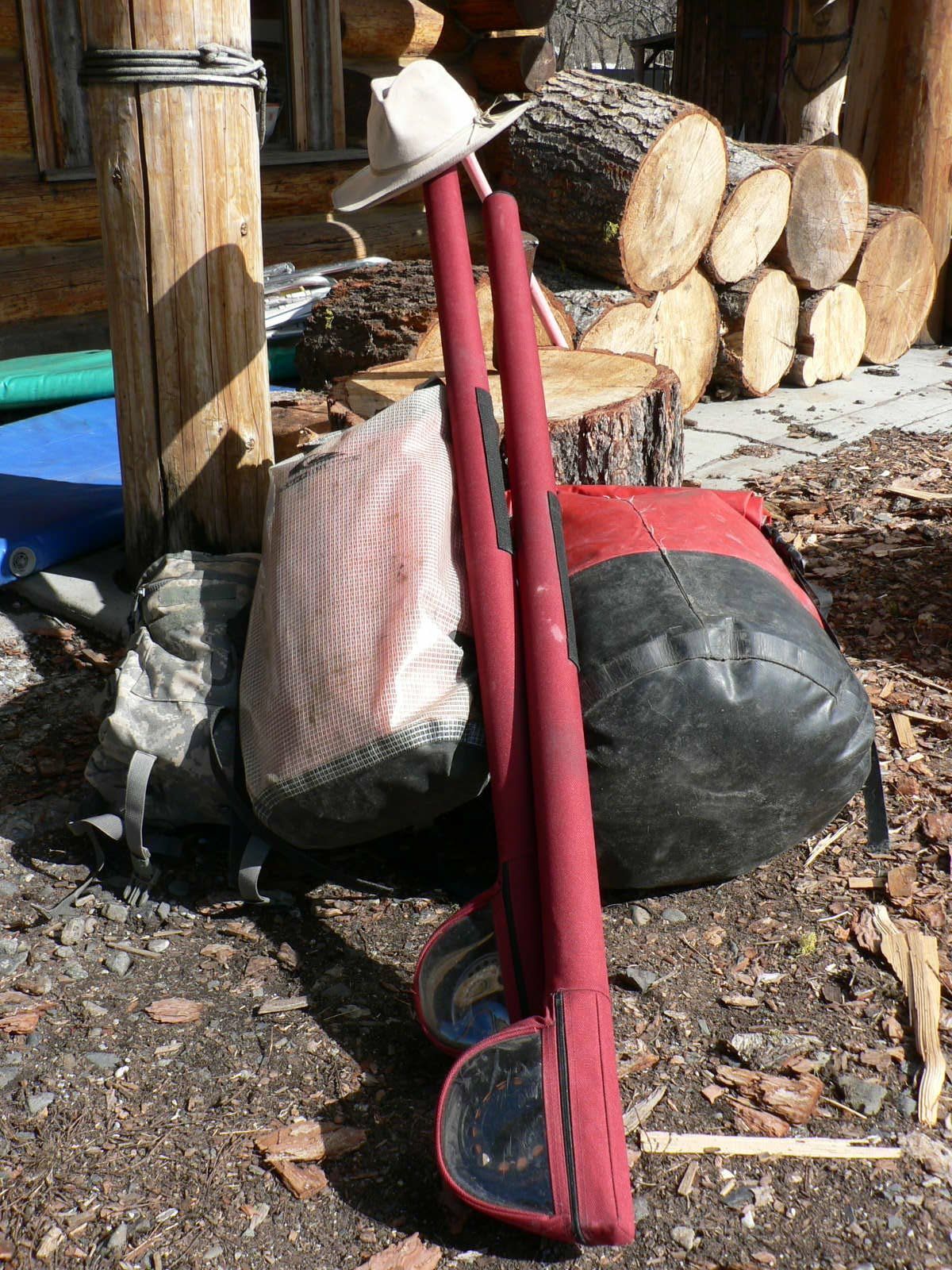 A cowboy hat is hanging from a red pole