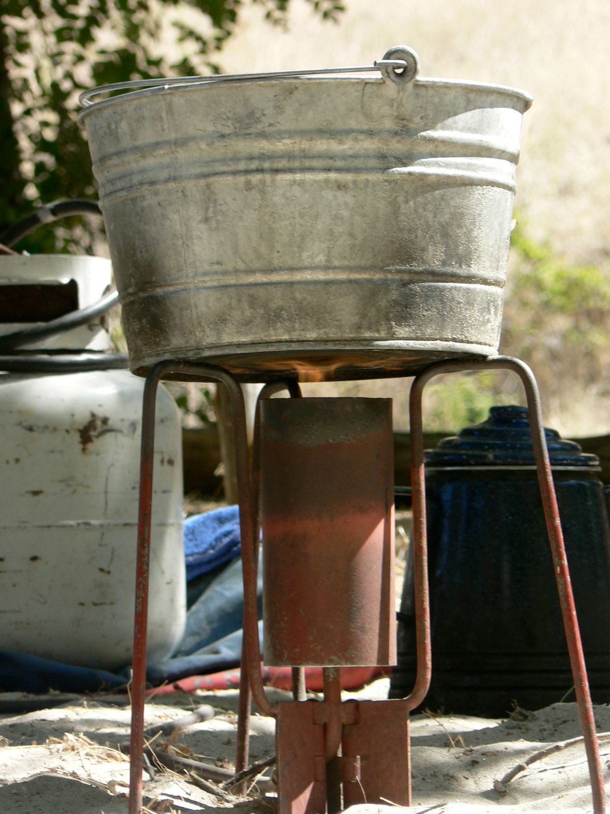 A metal bucket is sitting on top of a metal stand