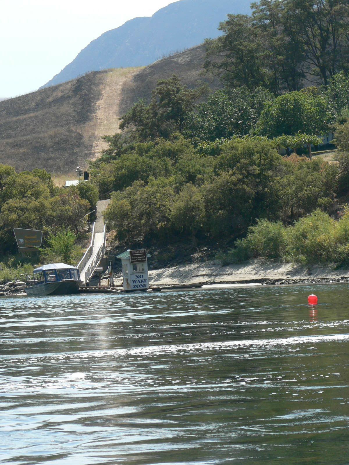 A red buoy in the middle of a body of water