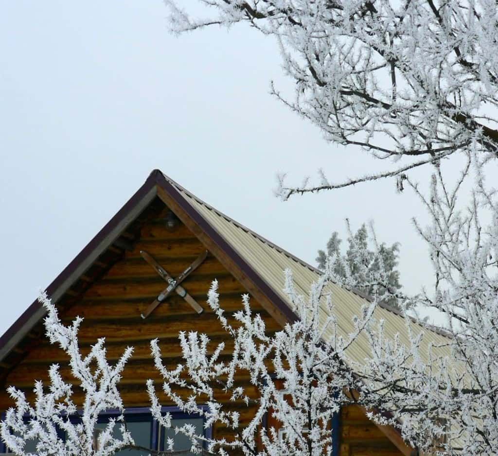 Log Cabin with A Roof that Is Covered in Snow